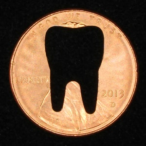 Lucky penny with tooth cut out