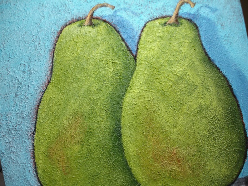 May include: A close-up of a painting featuring two green pears with textured surfaces. The pears have brown stems and are set against a textured, light blue background. The painting has a rustic, handmade aesthetic.
