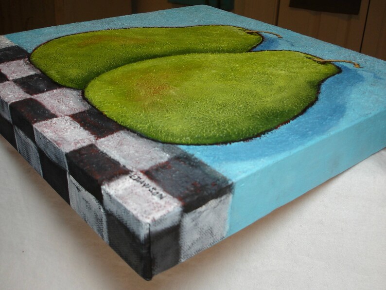 May include: A square canvas painting featuring two green pears on a light blue background. The painting has a checkerboard pattern on the left side, with a signature in the corner. The pears have a textured appearance.
