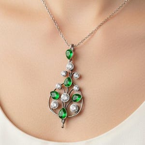 May include: A white ceramic mug with a black handle and the text "But First, Coffee" in a bold, black font. The mug is set against a blurred background, suggesting a cozy setting.