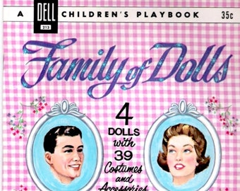May include: A vintage Dell Children's Playbook cover featuring a pink and white gingham background with four oval portraits of paper dolls. The title is "Family of Dolls" with glitter accents. The text below the title reads "4 Dolls with 39 Costumes and Accessories".