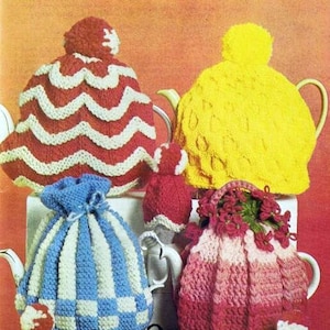 May include: A selection of hand-knitted tea cosies in a variety of colours and patterns, including red and white stripes, yellow, blue and white, and pink. Knitted egg cosies with faces are also shown.