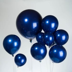 May include: A group of blue balloons, some large and some small, with a shiny, metallic finish.