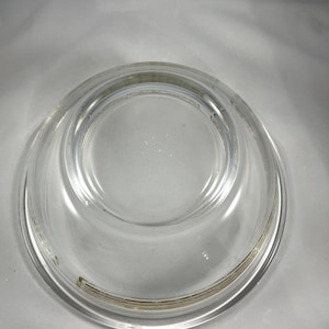 May include: A clear glass mixing bowl with a gold rim.