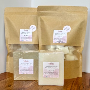 May include: Two brown paper bags and two wrapped blocks of soap. One bag and block are labeled "Stephenson Goat's Milk Melt and Pour Soap Base." The other bag and block are labeled "Stephenson HCVS Clear Melt and Pour Soap Base." Each block is 1 lb.