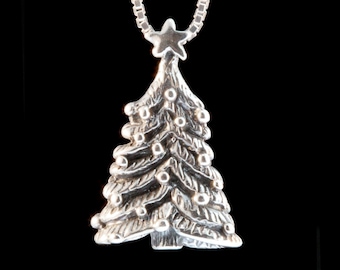 May include: A silver Christmas tree pendant with a star on top. The tree is decorated with small round baubles.