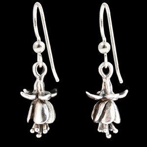May include: A pair of silver dangle earrings featuring a detailed fuchsia flower design.