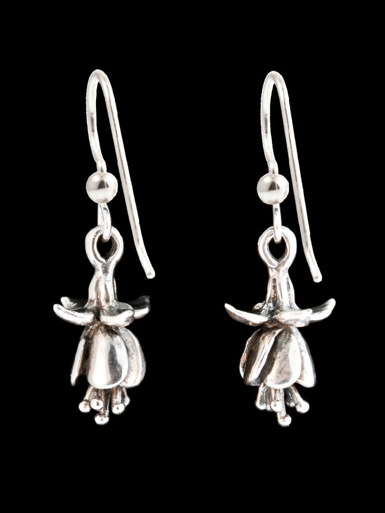 May include: A pair of silver dangle earrings featuring a detailed fuchsia flower design.