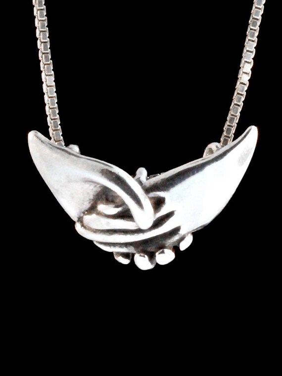 Clasped on sale hands necklace