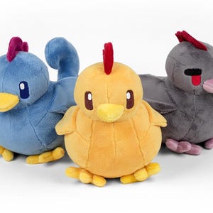 May include: Three plush toy chickens, one blue, one yellow, and one gray. The chickens have red combs and beaks.