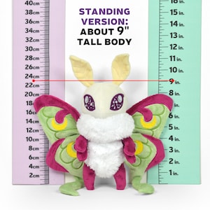 May include: A plush Luna moth toy, approximately 9 inches tall, with a cream-colored body, large pink and green wings, and yellow antennae. The text "STANDING VERSION: ABOUT 9" TALL BODY" is visible.