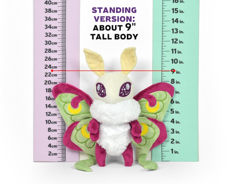 May include: A plush Luna moth toy, approximately 9 inches tall, with a cream-colored body, large pink and green wings, and yellow antennae. The text "STANDING VERSION: ABOUT 9" TALL BODY" is visible.