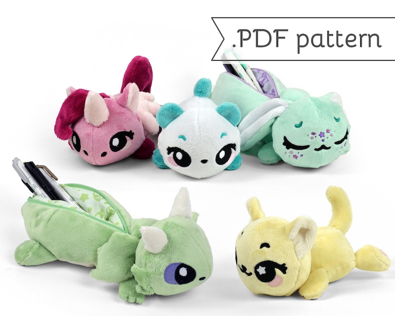 May include: Five plush toy pencil cases in the shapes of a unicorn, panda, cat, dragon, and a cat. The pencil cases are open to reveal a zipper and a lined interior. The text '.PDF pattern' is visible in the top right corner of the image.
