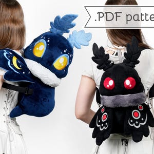 May include: Two plush backpacks shaped like moths. One is navy blue with yellow eyes and a crescent moon design. The other is black with red eyes and a gray fur collar. The text ".PDF pattern" is visible.