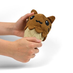 May include: A brown plush toy shaped like an ice cream cone with a cat face on top. The cat has black eyes and a brown nose.