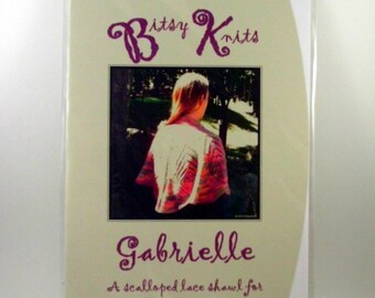May include: A knitting pattern for a scalloped lace shawl called "Gabrielle" by Bitsy Knits. The pattern is for worsted or lace weight yarn.