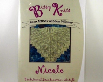 May include: A cream-colored knitted shawl with a geometric pattern. The shawl is a 2010 MDSW Ribbon Winner and is called "Nicole". The text on the label reads "Traditional Scandinavian Motifs in a top down triangular shawl".