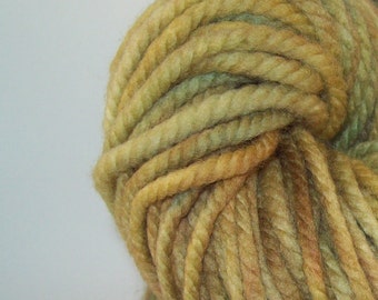 May include: A skein of yarn in shades of green, brown, and yellow. The yarn is twisted and has a rustic, hand-spun look.