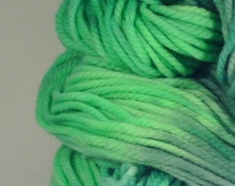 May include: A skein of green and blue ombre yarn. The yarn is soft and fluffy, and it is perfect for knitting or crocheting.