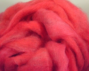 May include: A close-up of a bright pink, sparkly yarn. The yarn is soft and fluffy, and it has a subtle shimmer.