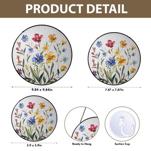 May include: Round floral wall art with a textured glass appearance. The design features colorful flowers in red, blue, and yellow, with green stems and leaves. Sizes include 9.84 x 9.84 inches, 7.87 x 7.87 inches, and 5.9 x 5.9 inches. The text "Ready to Hang" and "Suction Cup" are also visible.