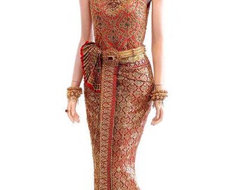 May include: A floor-length dress in a deep red and gold metallic fabric featuring an intricate repeating pattern. The garment includes a sleeveless bodice with a scoop neckline, a fitted waist with a decorative belt, and a draped side panel.