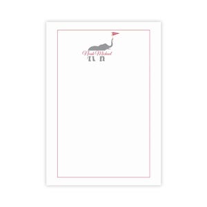 May include: White stationery with a red border and a grey elephant illustration holding a red flag. The name "Noah Michael" is written in cursive above the elephant. The elephant has the letters "N" and "M" below it.