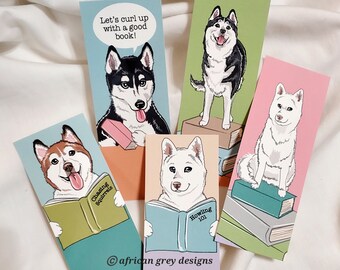 May include: Set of five illustrated bookmarks featuring different dog breeds reading books. The bookmarks are printed on cardstock and feature a variety of colors and designs. The text on the bookmarks includes "Chasing Squirrels", "Let's curl up with a good book!" and "Howling 101".
