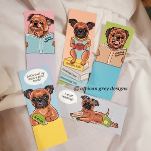May include: Set of six colorful bookmarks featuring illustrations of Brussels Griffon dogs in various poses. Each bookmark has a different quote about reading and dogs, such as "Let's curl up with a good book!" and "I wuff reading!"