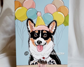 May include: A birthday card featuring a cartoon corgi wearing a party hat and holding a cupcake. The corgi is surrounded by colorful balloons. The card has the text "african grey designs" in the bottom right corner.