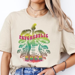 May include: A beige t-shirt with a graphic of a psychedelic guitar surrounded by mushrooms. The text "PSYCHEDELIC ROCK" is printed on the shirt.