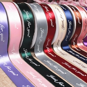 May include: A collection of satin ribbons in various colors including purple, pink, dark green, silver, red, cream, navy blue, brown, and light pink. Each ribbon features the repeating white cursive text "Just for you" with a small heart icon.