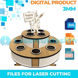 May include: A two-tiered wooden Easter display with a bunny holding a "Happy Easter" sign. The display has multiple circular holes for holding items. The words "DIGITAL PRODUCT" and "FILES FOR LASER CUTTING" are also visible.