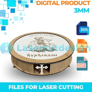 May include: A round wooden box with a white top featuring an illustration of a saint on horseback slaying a dragon, with Cyrillic text. The box has a cross design on the front and the text "FILES FOR LASER CUTTING".