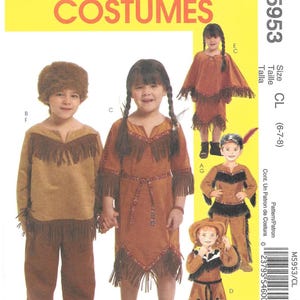 May include: McCall's M5953 sewing pattern for children's costumes in size CL (6-7-8). The envelope features illustrations of various brown suede-look outfits with fringe details, including a tunic, pants, a dress, and a poncho, along with a barcode.