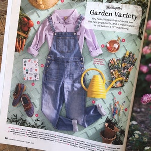 May include: A flat lay of gardening essentials, including a pair of blue denim overalls, a light purple button-down shirt, a yellow watering can, a pair of brown leather shoes, a floral gardening glove, and a set of colorful gardening tools. The text "Garden Variety" is written in a white box.