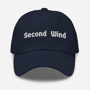 Può includere: Cappellino da baseball blu navy con la scritta ricamata "Second Wind" in bianco. Il cappellino ha una visiera curva e un design a sei pannelli, adatto all'abbigliamento casual.