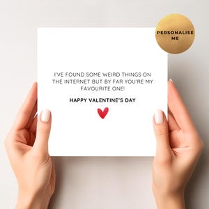 May include: A white Valentine's Day card with the message "I'VE FOUND SOME WEIRD THINGS ON THE INTERNET BUT BY FAR YOU'RE MY FAVOURITE ONE! HAPPY VALENTINE'S DAY" and a red heart. A gold sticker with the text "PERSONALISE ME" is in the upper right corner.