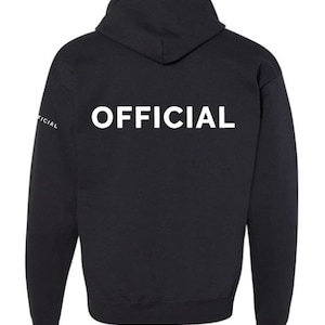 May include: Black hooded sweatshirt with the word "OFFICIAL" printed in white on the back.