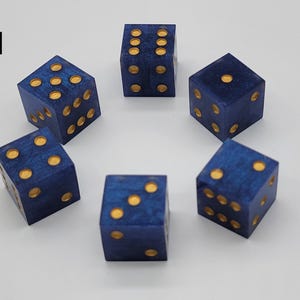 May include: Six blue dice with a marbled texture and gold-colored pips arranged in a circular pattern. Each die is a cube with rounded edges. The number 11 is printed in black in the upper left corner of the image, indicating the set number.