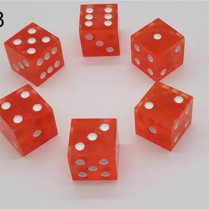 May include: A set of six translucent orange dice arranged in a circle, each featuring white circular pips on its faces. The number eight is printed in black in the upper left corner of the image, indicating the specific set or item number.