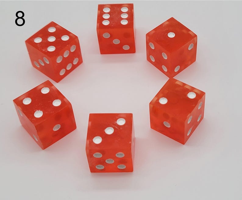 May include: A set of six translucent orange dice arranged in a circle, each featuring white circular pips on its faces. The number eight is printed in black in the upper left corner of the image, indicating the specific set or item number.