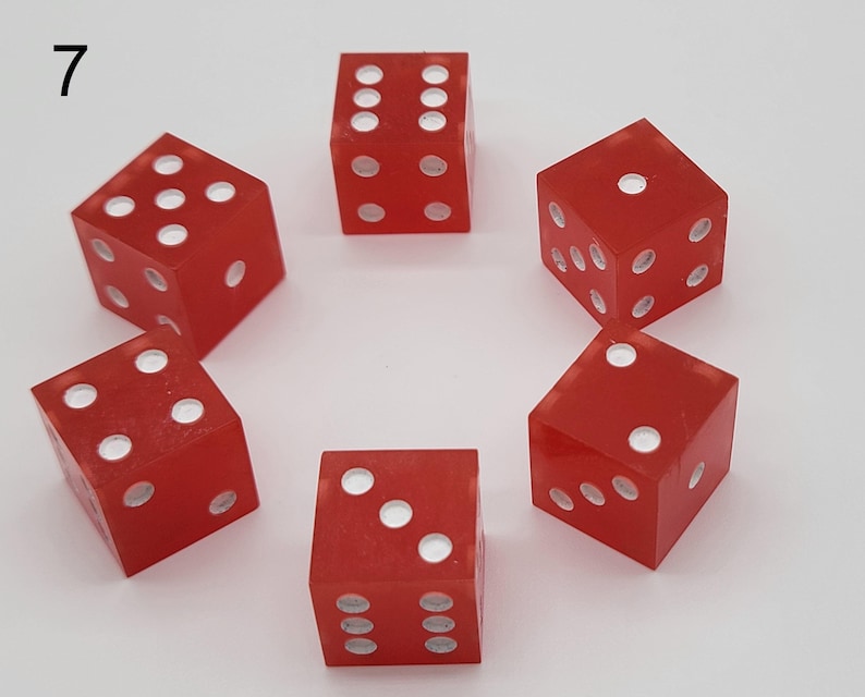 May include: Six translucent red six-sided dice arranged in a circular pattern. Each die features white circular pips representing numbers one through six. The number 7 is printed in black in the upper left corner of the image frame.