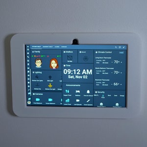 May include: A white-framed smart home control panel displaying various home automation features. The screen shows time, temperature, lighting controls, and security options. The time displayed is 09:12 AM, Saturday, November 2nd.