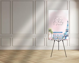 Könnte beinhalten: Ein Schild auf einer schwarzen Staffelei mit dem Text "Bonjour Welcome to Callie's Birthday a Paris!" zeigt eine Aquarellillustration des Eiffelturms und eines Pariser Cafés in Rosa und Blau. Das Schild wird in einem Raum mit hellem Holzboden angezeigt.