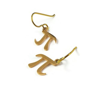 May include: A pair of gold-coloured earrings shaped like the mathematical symbol pi.