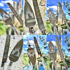 May include: Collection of silver cake servers and knives with clear crystal handles. Each features a different etched design, including a castle, silhouettes of characters, and text such as "Once Upon a Dream" and "Be Our Guest".