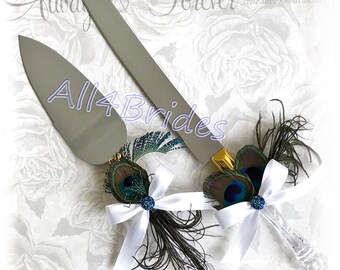 Peacock wedding cake knife and serving set gold accent and peacock feathers.