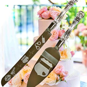 May include: A set of two silver cake cutting knives with clear acrylic handles. The knives are engraved with police-themed designs, including a badge, handcuffs, a gun, and a heartbeat.