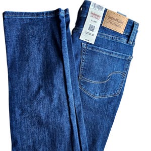 May include: A pair of dark blue denim jeans with a back pocket featuring the Levi Strauss Signature logo. The jeans have a straight leg fit and are made of a soft, comfortable fabric.